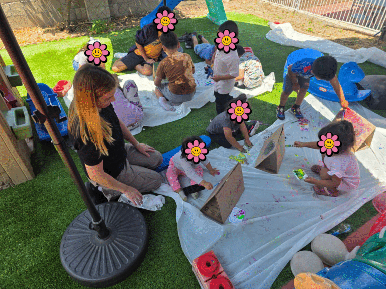 Children painting outside.