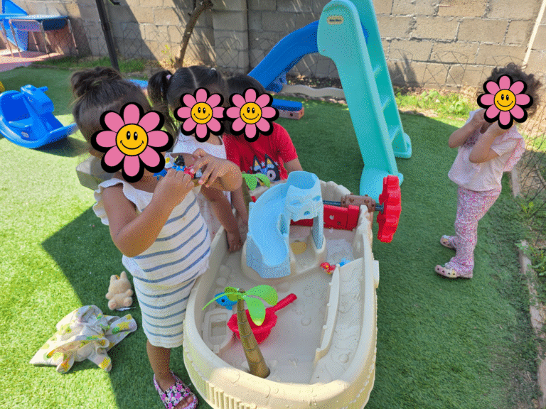 Children playing outside with water toys.