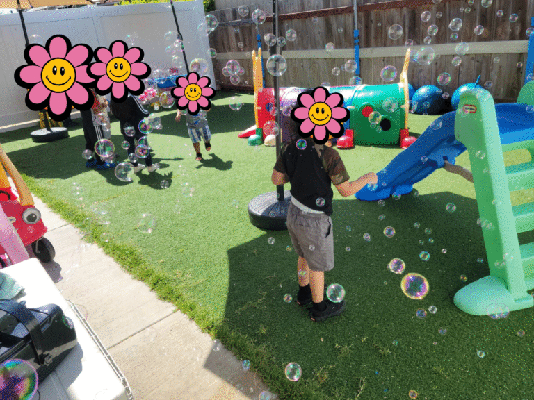 Children playing with bubbles outside.